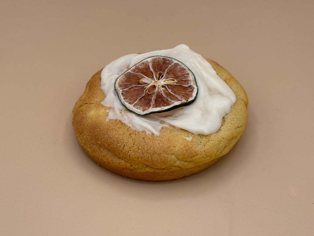 Silk Citron cookie close-up showing lemon-zested dough with white chocolate glaze and dried citrus crown — Dubai House Halal cookie
