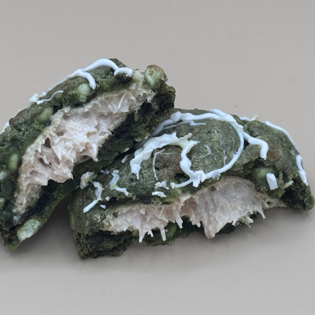 Jade Eclipse cookie broken in half showing molten white chocolate kunafa filling against deep green matcha dough — Dubai House OKC