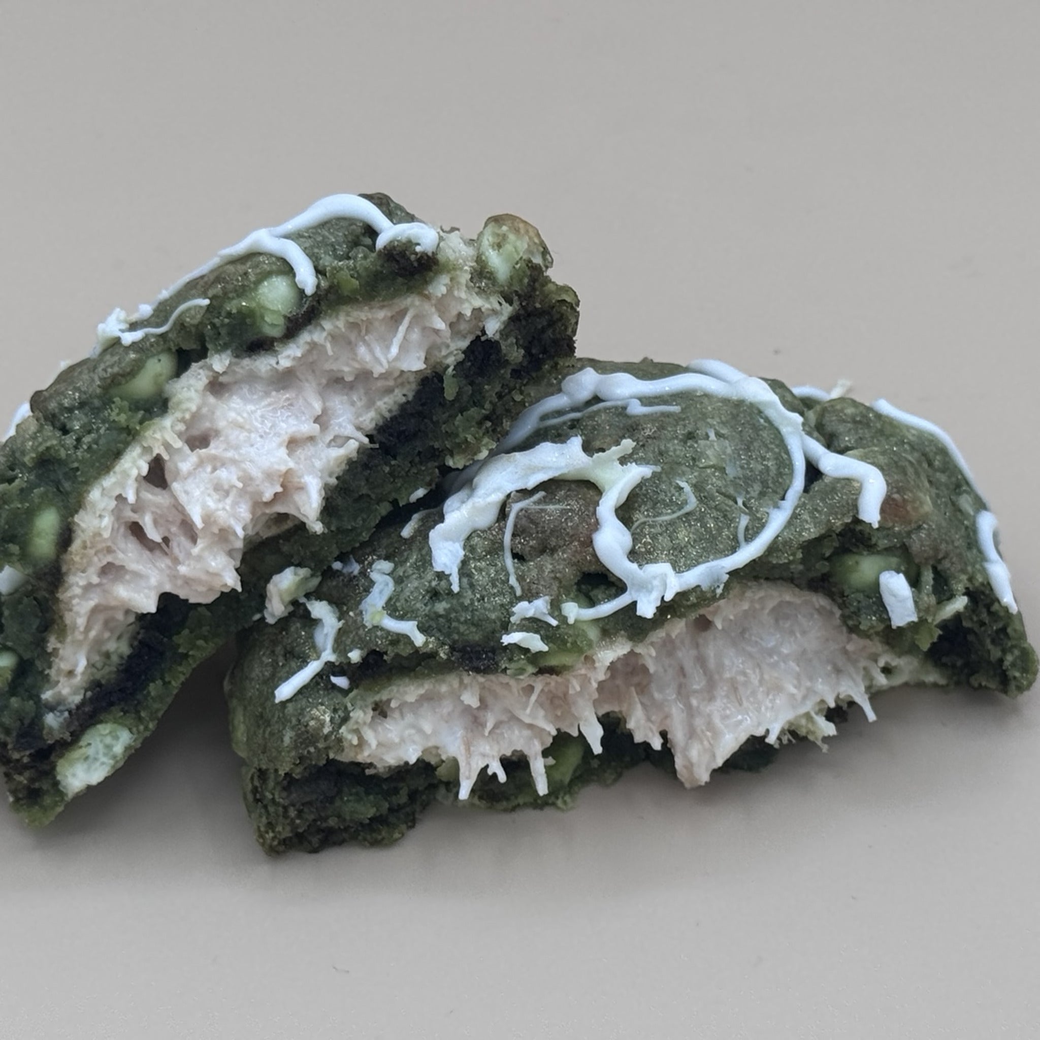 Jade Eclipse cookie broken in half showing molten white chocolate kunafa filling against deep green matcha dough — Dubai House OKC